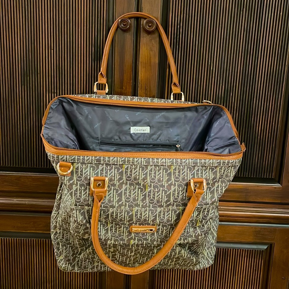 Calvin Klein travel bag or carry on bag on a plane.  Roomy with compartments.